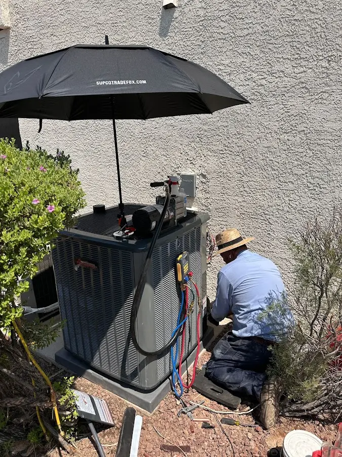 HVAC technician performing outdoor AC maintenance in Apex